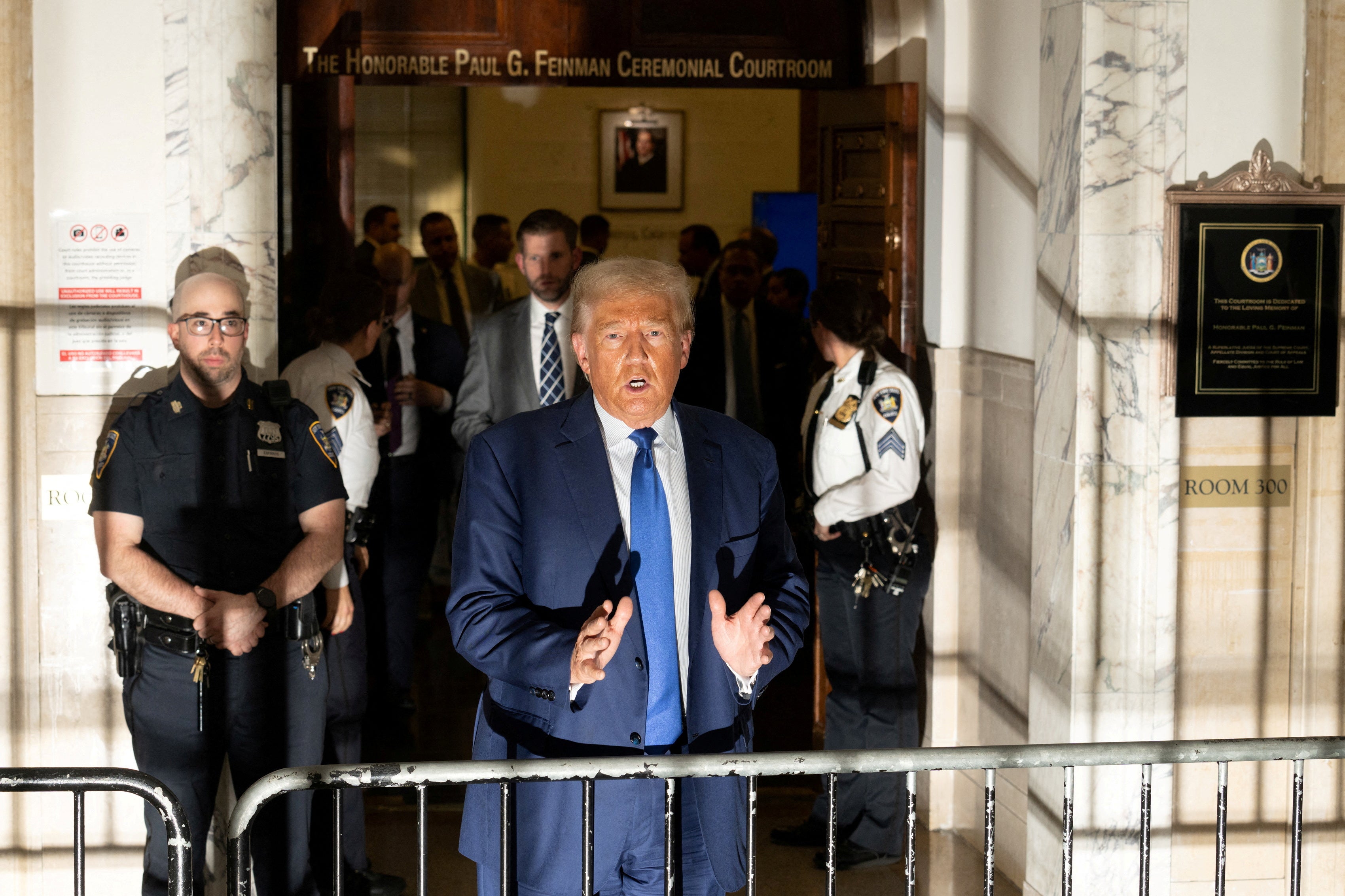 <p>Donald Trump speaks to reporters steps away from Judge Arthur Engoron’s courtroom on 25 October. </p>