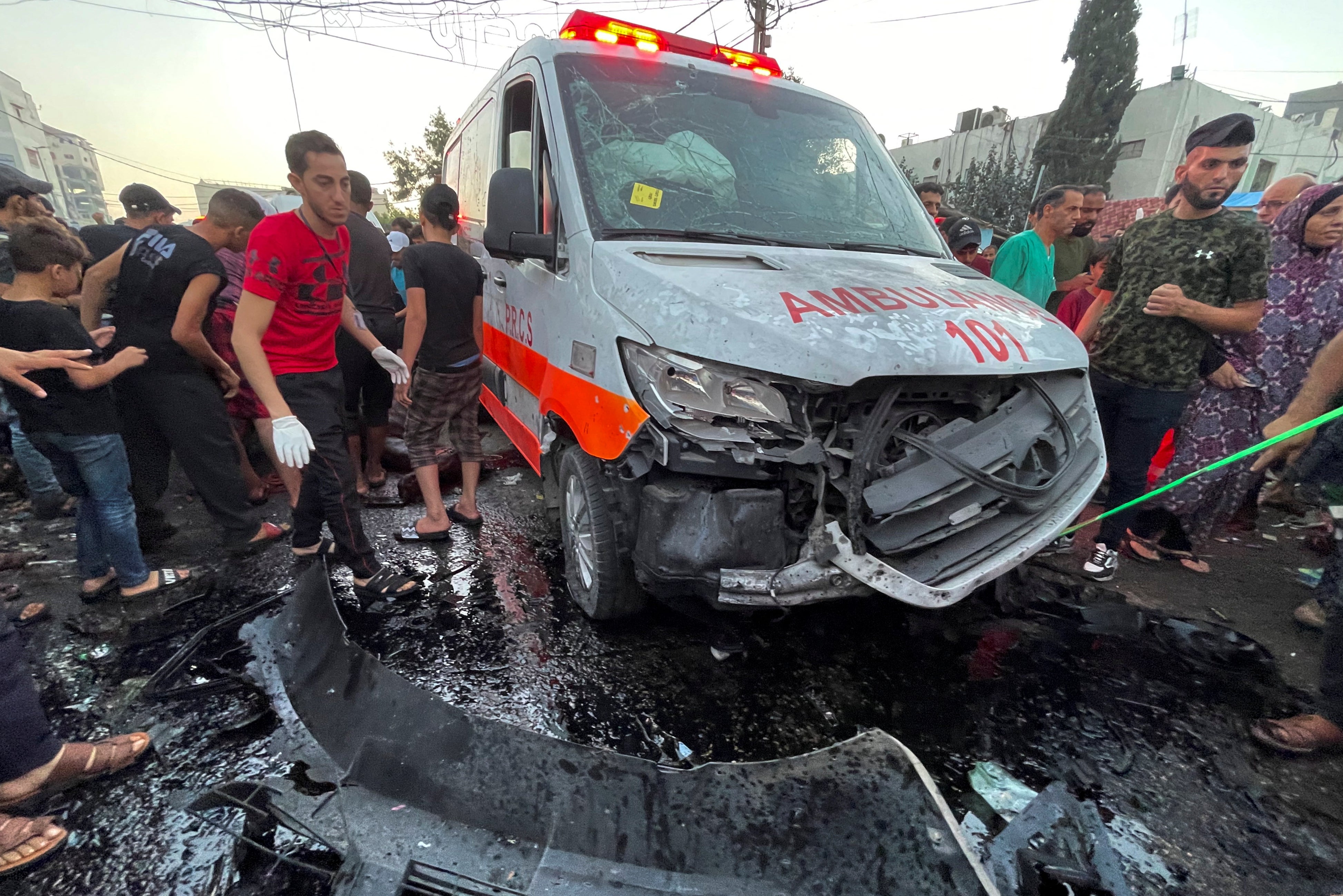 Palestinians help the victims of an Israeli airstrike that hit an ambulance on Friday