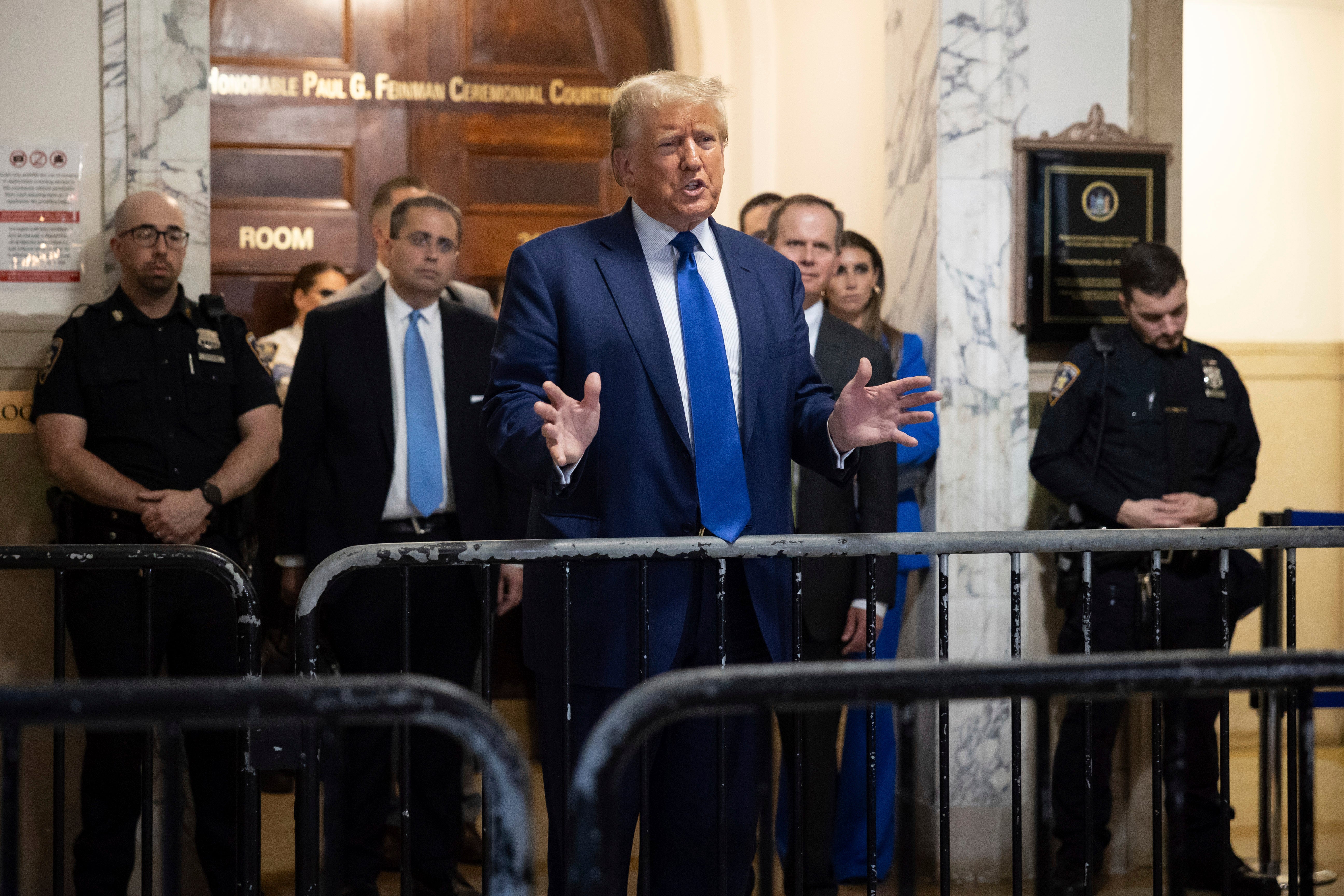 Donald Trump speaks to reporters after leaving Judge Arthur Engoron’s courtroom on 25 October.