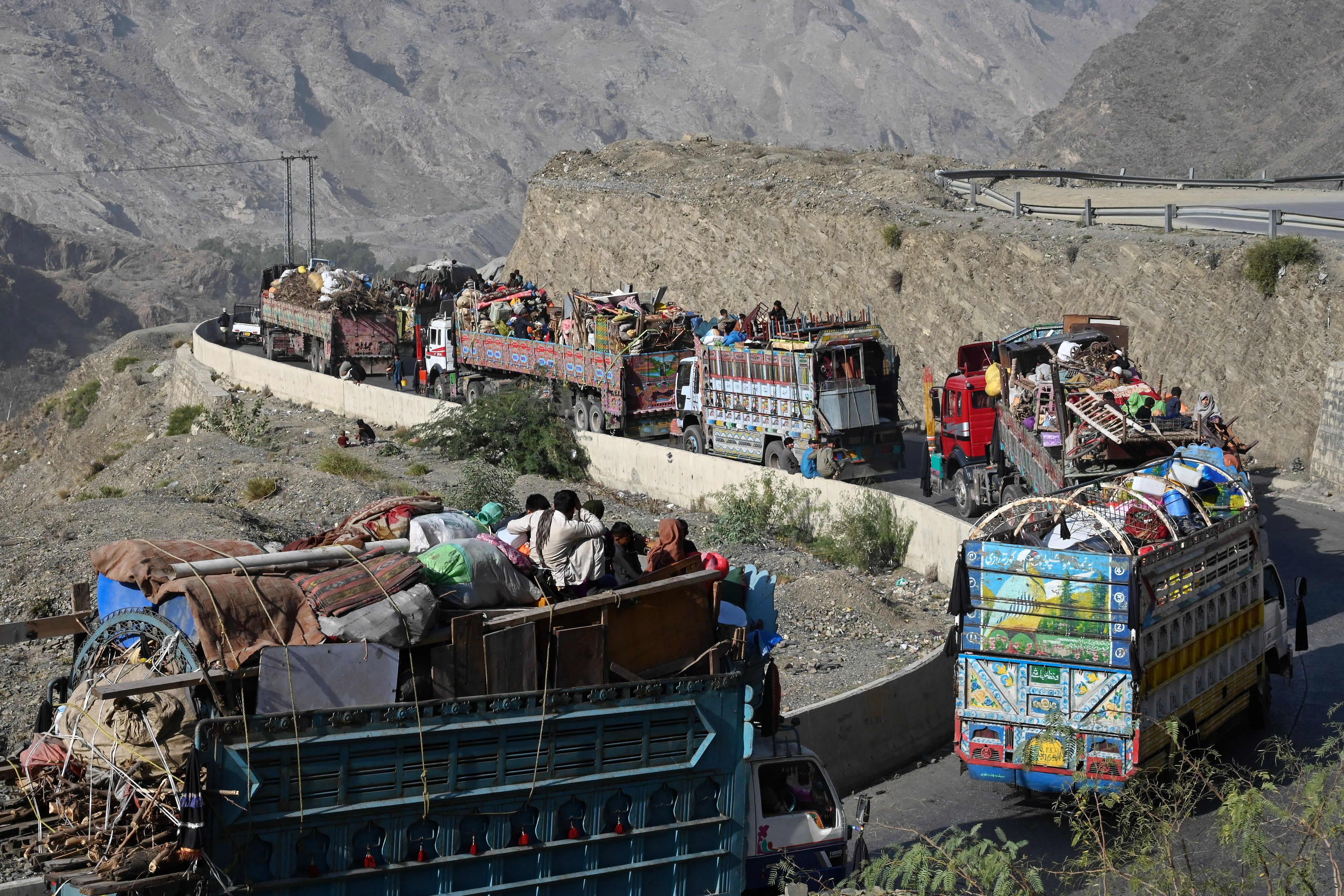 <p>Trucks transporting Afghan refugees with their belongings are seen along a road towards the Pakistan-Afghanistan Torkham border</p>