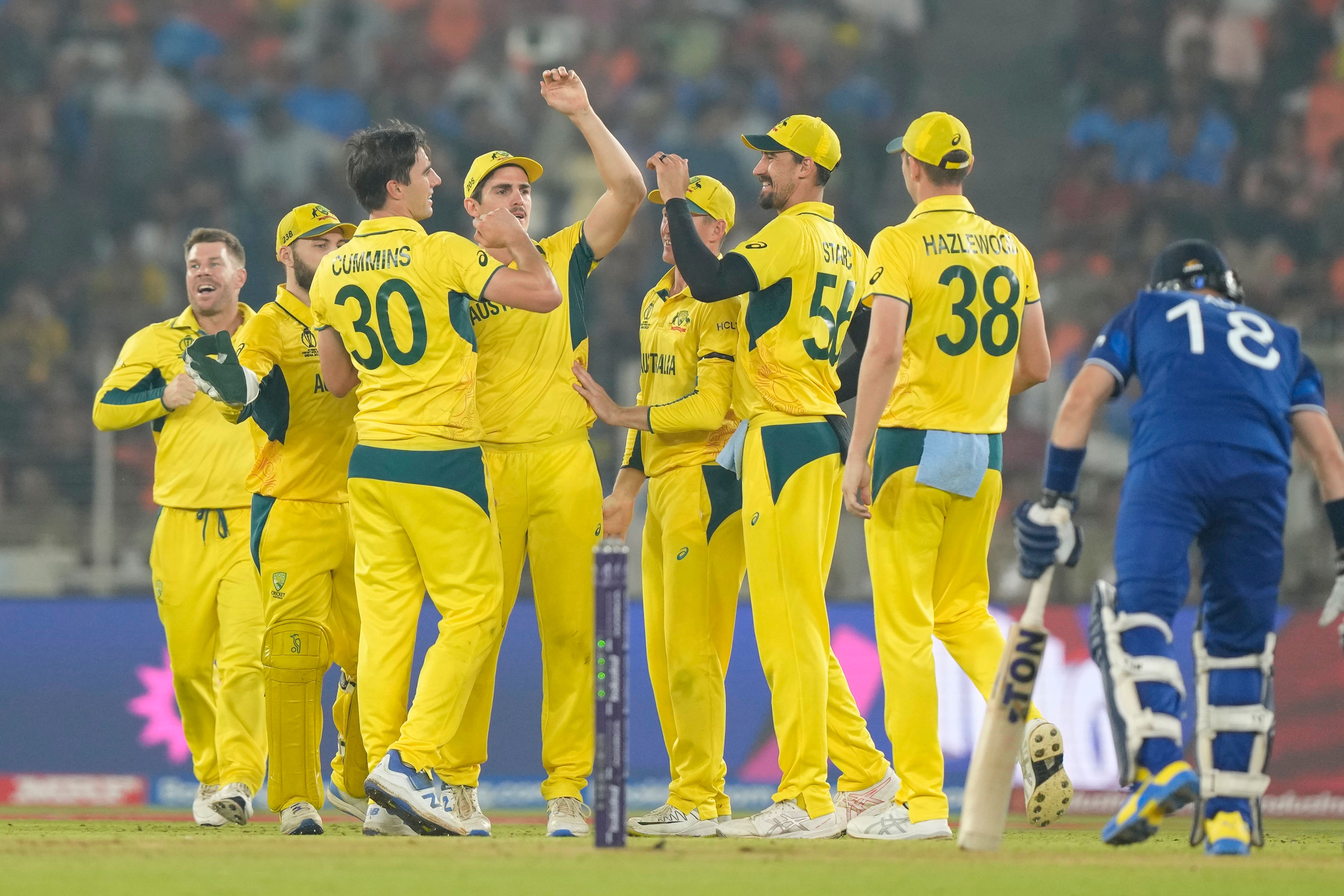 Australia beat England by 33 runs, knocking the defending champions out of the tournament