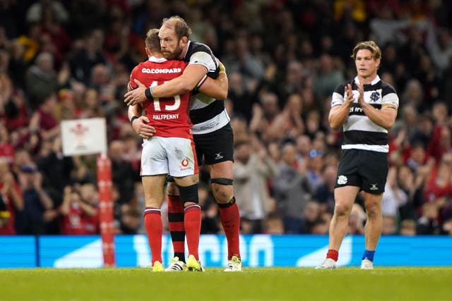 Wales fullback Leigh Halfpenny (left) hugs Barbarians captain Alun Wyn Jones as he leaves the field after his final appearance for his country (Joe Giddens/PA).