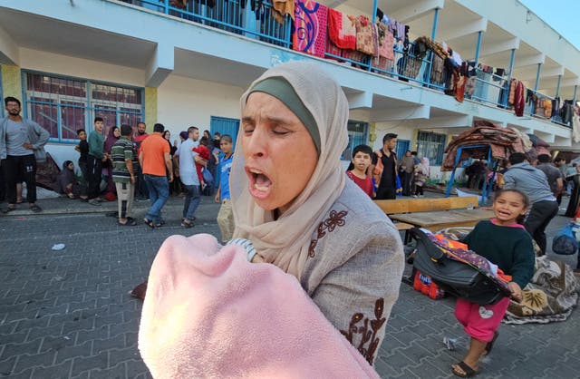 <p>Palestinians react following a strike at a UN-run school sheltering displaced people</p>