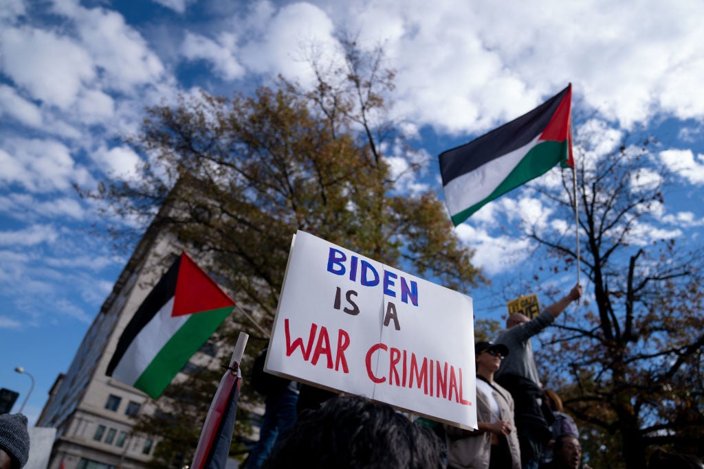 A person holds up a sign denouncing Joe Biden at Saturday’s March for Palestine in Washington