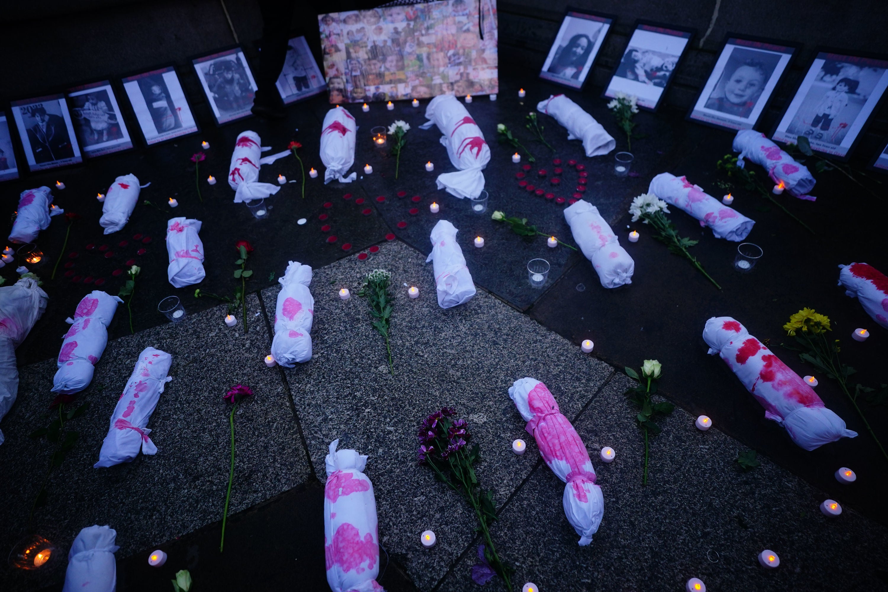 Effigies of dead babies were left on the ground in Trafalgar Square, next to pictures of children and candles.