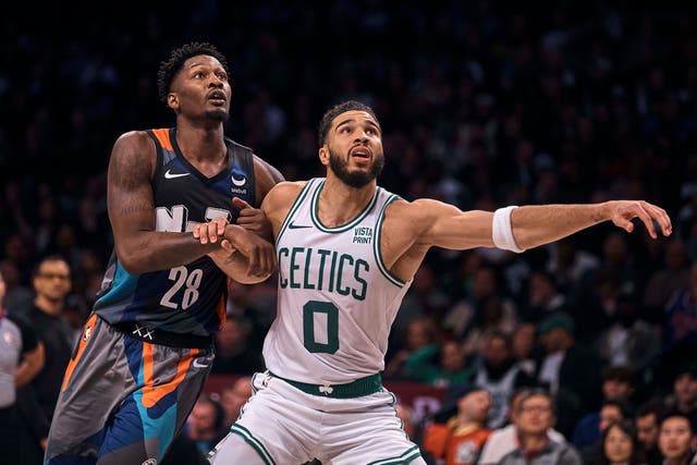 Boston Celtics’ Jayson Tatum, right, and Brooklyn Nets’ Dorian Finney-Smith look for a rebound (Andres Kudacki/AP)