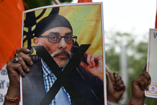 <p>A banner depicting Gurpatwant Singh Pannun, a lawyer believed to be based in Canada designated as a Khalistani terrorist by the Indian authorities, during a rally along a street in New Delhi</p>