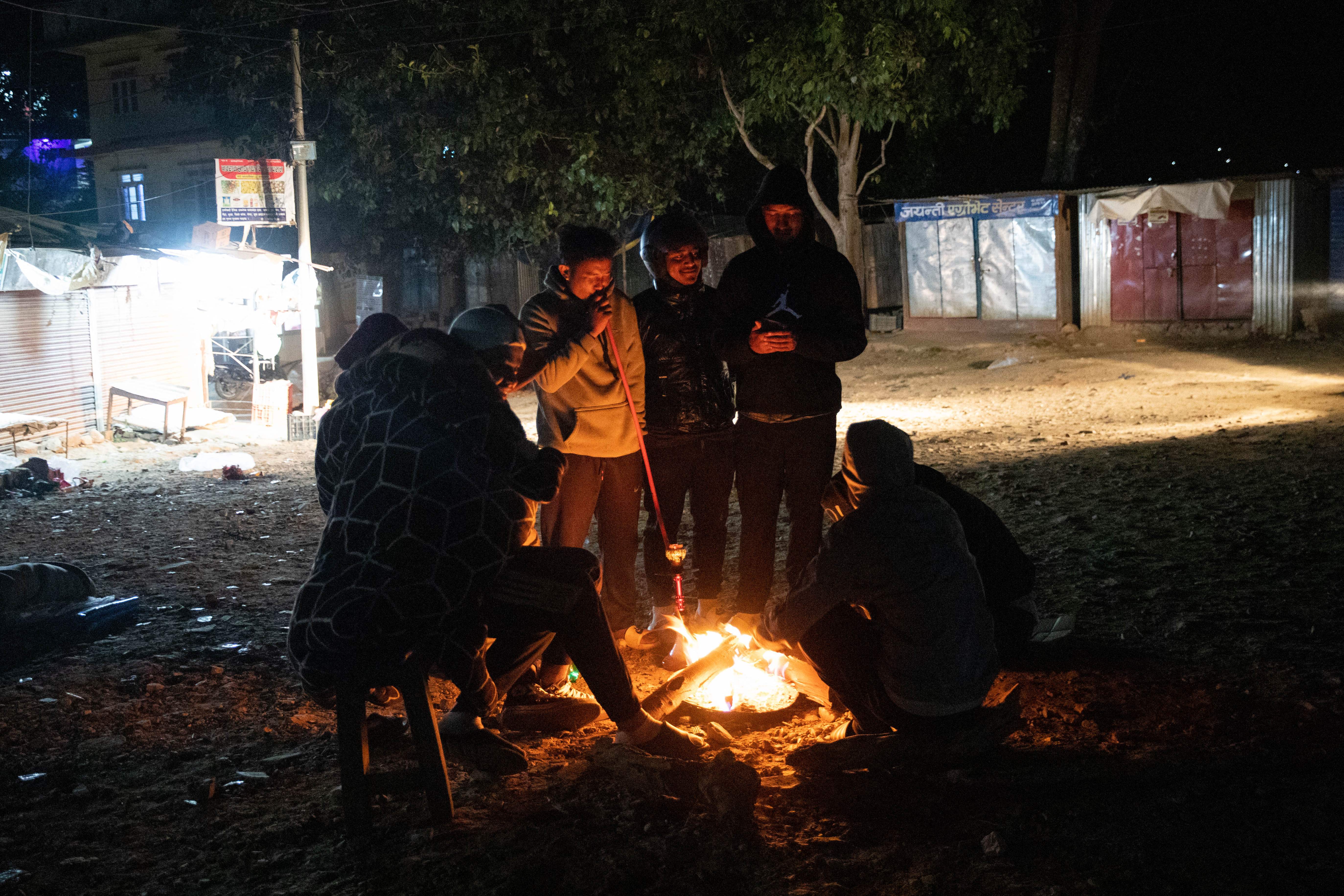 Residents gather around a fire in Jajarkot district after a 5.6-magnitude earthquake