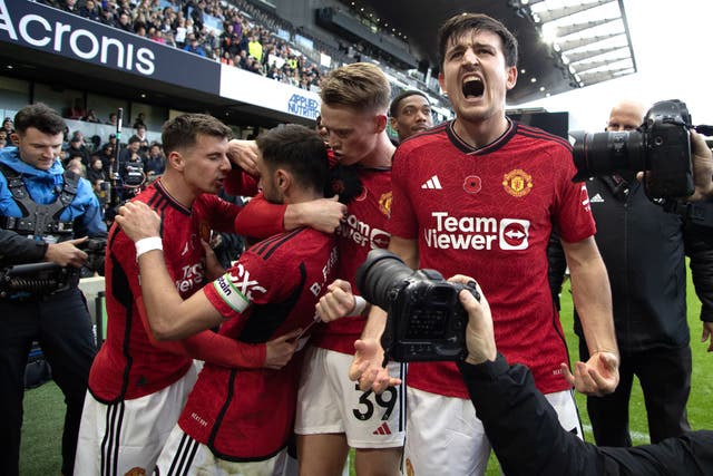 Harry Maguire, right, and Manchester United celebrate Bruno Fernandes’ winner against Fulham (Kieran Cleeves/PA)