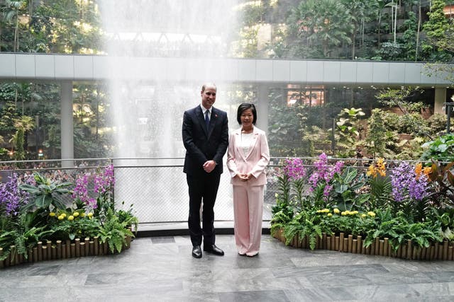 The Prince of Wales with Sim Ann, Singapore’s senior minister of state for foreign affairs and senior minister of state for national development, at the world’s tallest indoor waterfall, the Rain Vortex, as he arrives at Jewel Changi Airport in Singapore, ahead of the third annual Earthshot Prize Awards ceremony (Jordan Pettitt/PA)