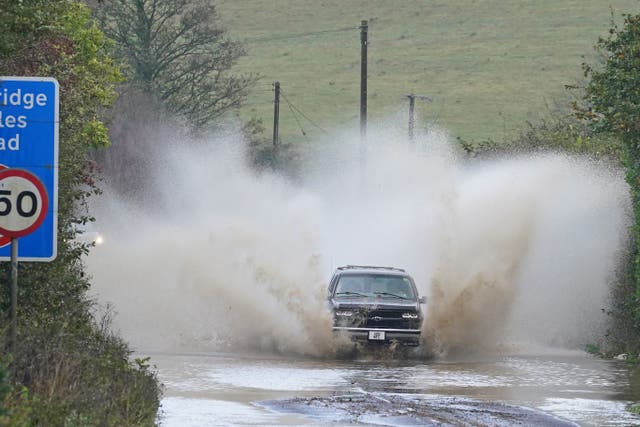 A car drives through floodwater near Folkestone, Kent (Gareth Fuller/PA)