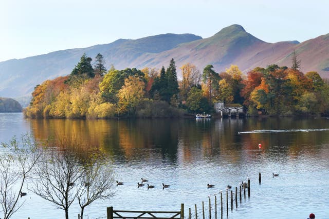 Autumn colours on the trees on Derwent island on Derwentwater in the Lake District (Owen Humphreys/PA)