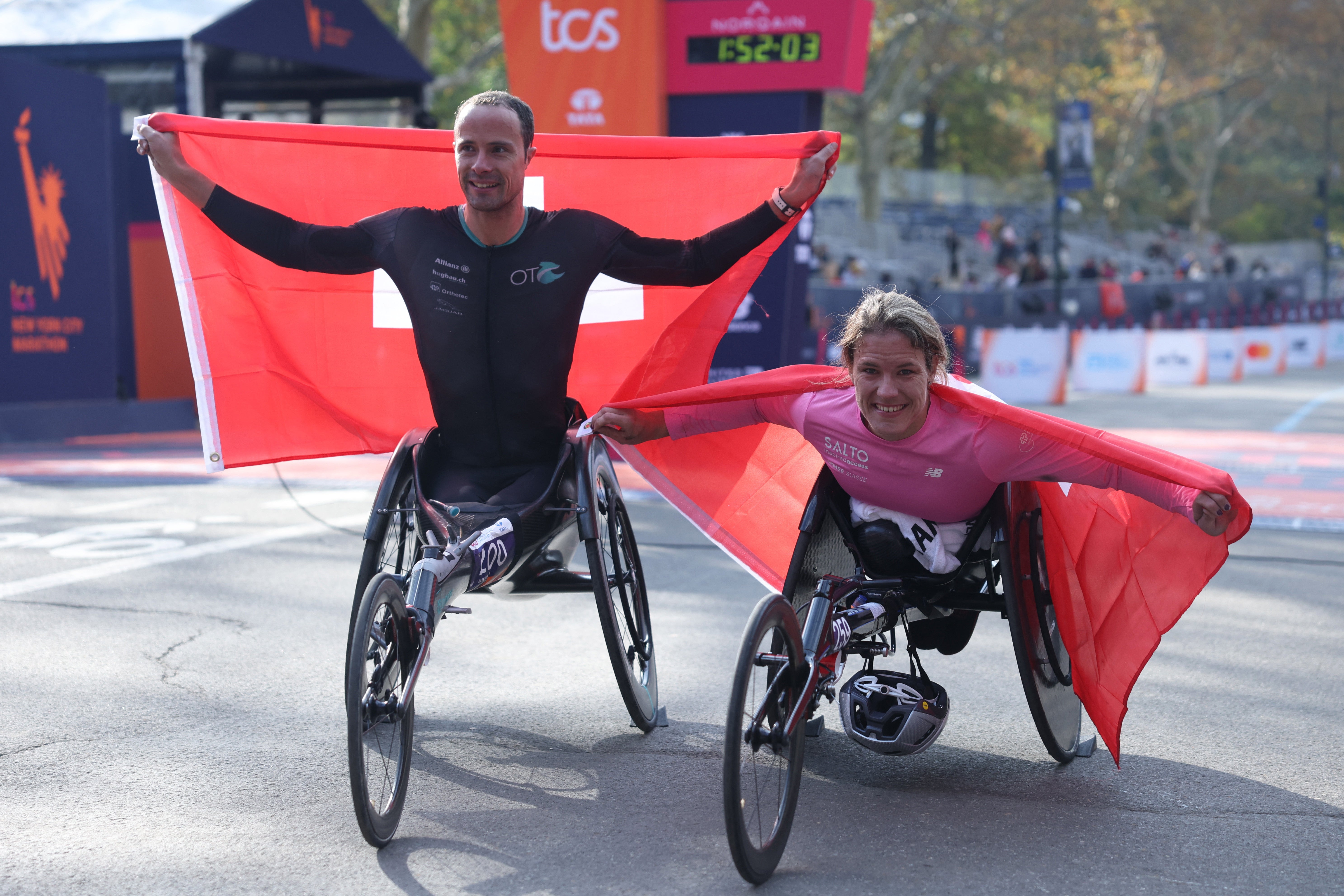 Marcel Hug and Catherina Debrunner celebrate their victories in the wheelchair races