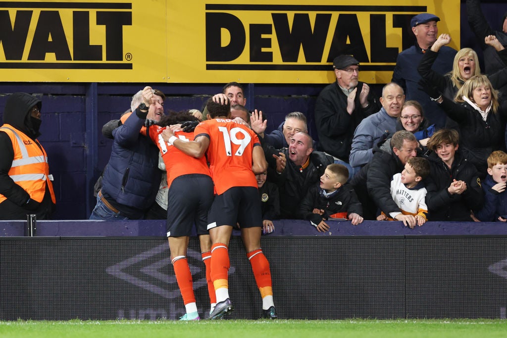 Tahith Chong celebrates with Jacob Brown (19) and the Kenilworth Road fans after his goal put Luton ahead