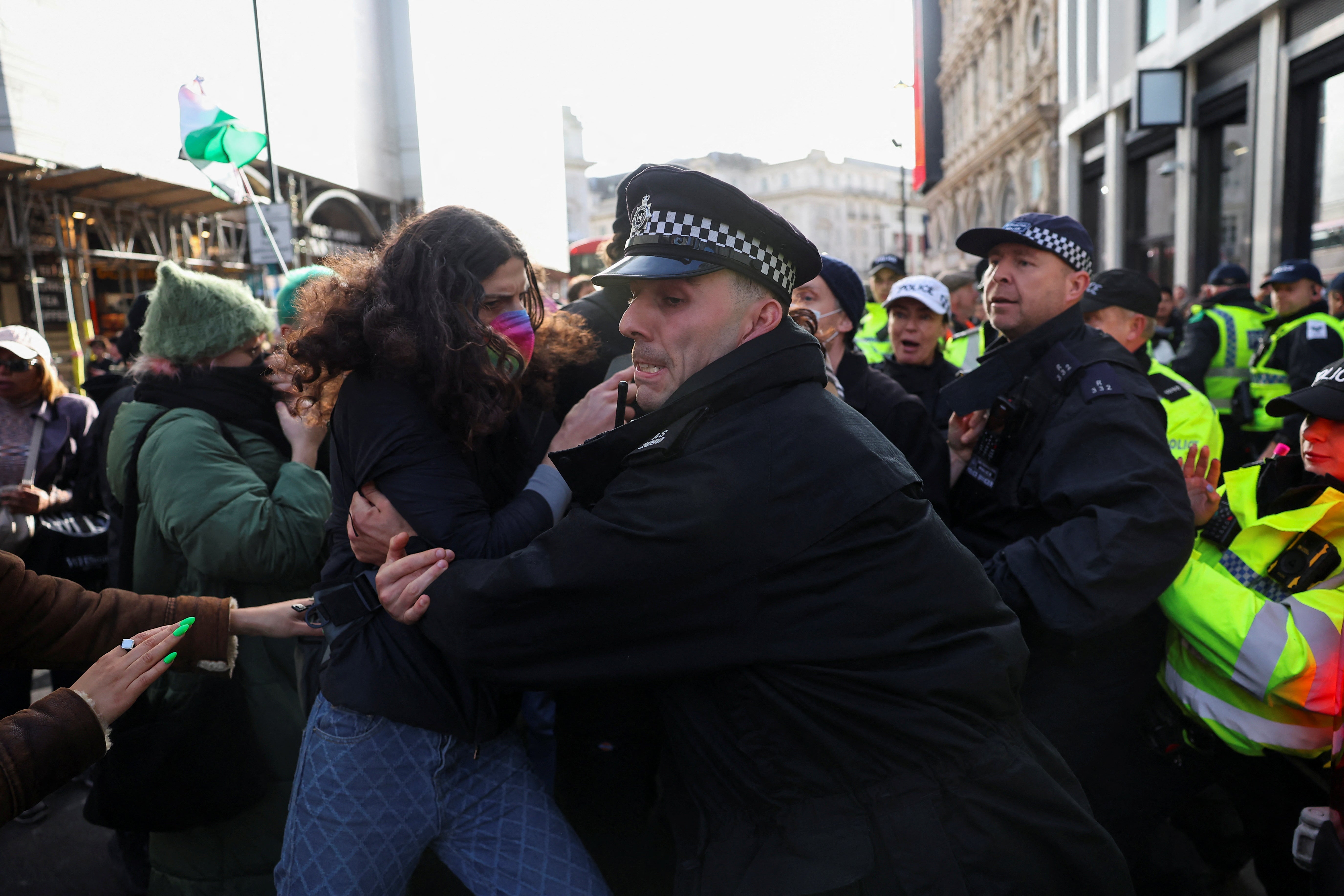 A police officer clashes with a demonstrator during the protest in solidarity with Palestinians in London on 4 November