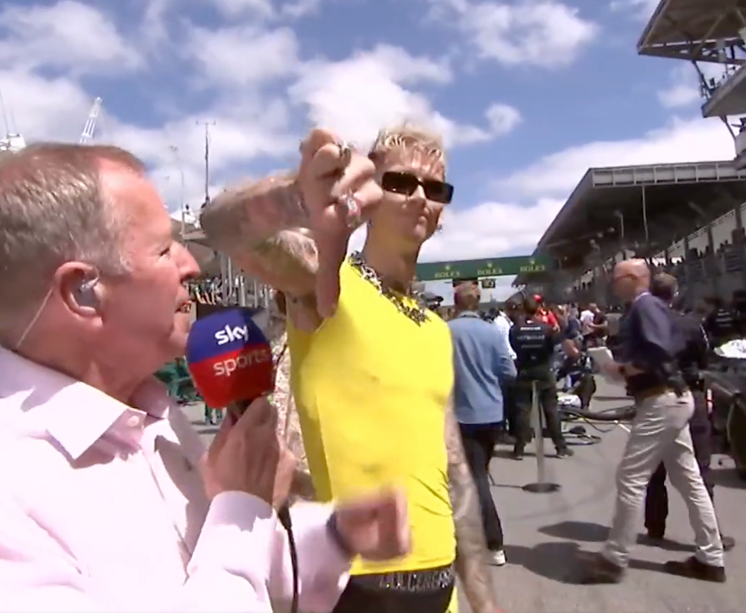 Machine Gun Kelly puts his thumb down to the camera after a bizarre exchange with Martin Brundle in Brazil