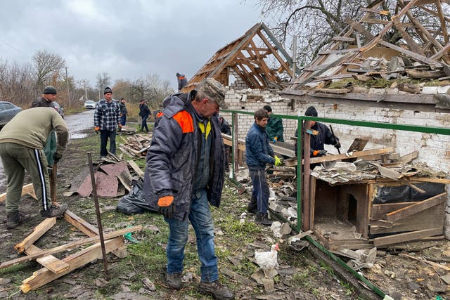 <p>Local residents clean up rubble from residential house in Poltava Oblast</p>