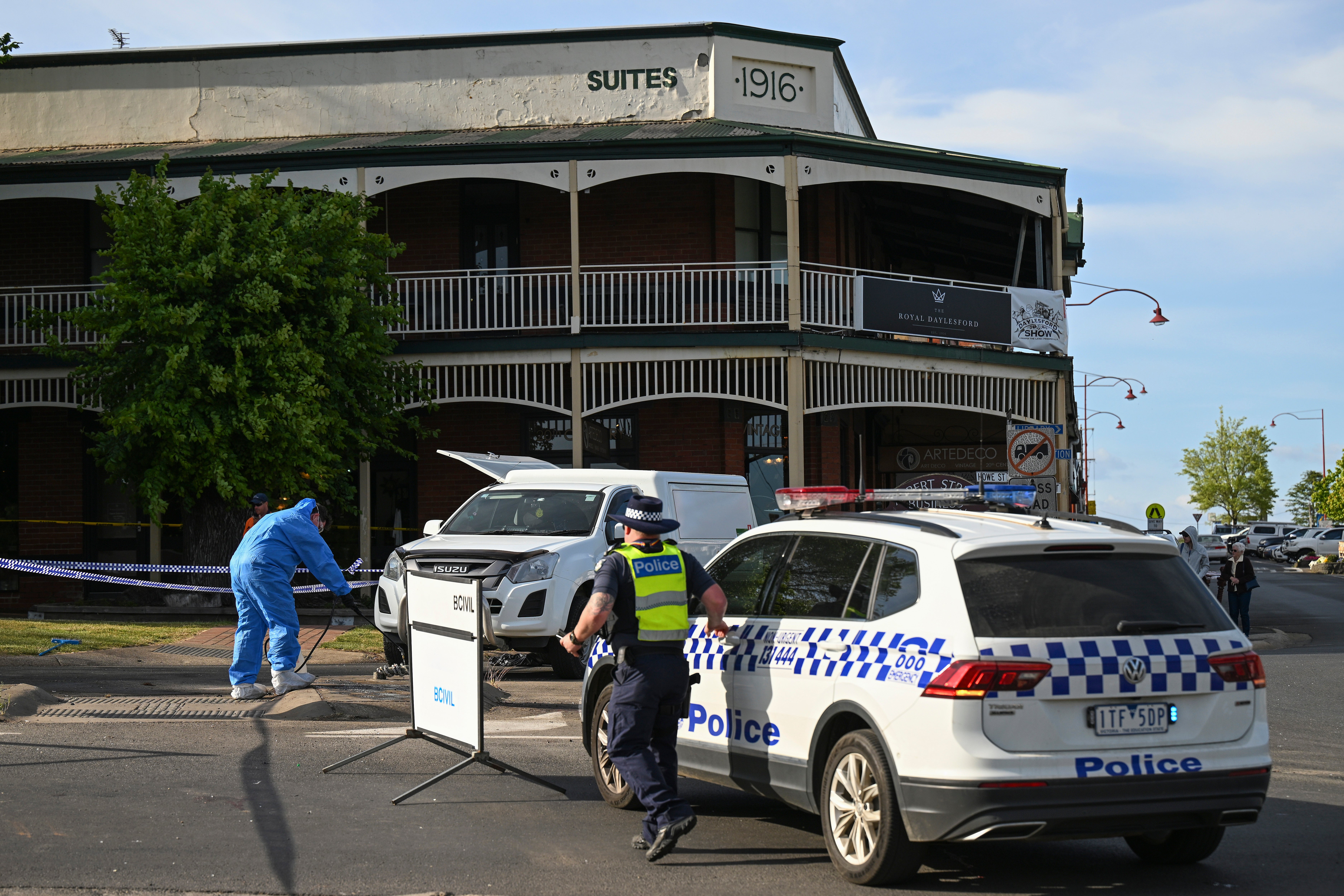 Victorian police work the scene of a deadly car crash outside the Royal Hotel in Daylesford, Australia on Monday