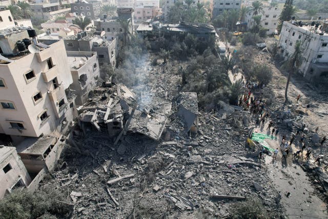 <p>File. Palestinians gather at the site of an Israeli strike on a house in Deir Al-Balah, in central Gaza Strip, 6 November 2023</p>