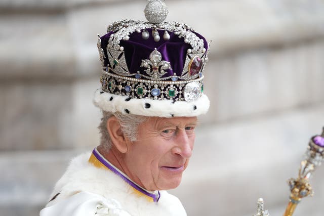 <p>Charles wearing the Imperial State Crown as he leaves his coronation in May </p>