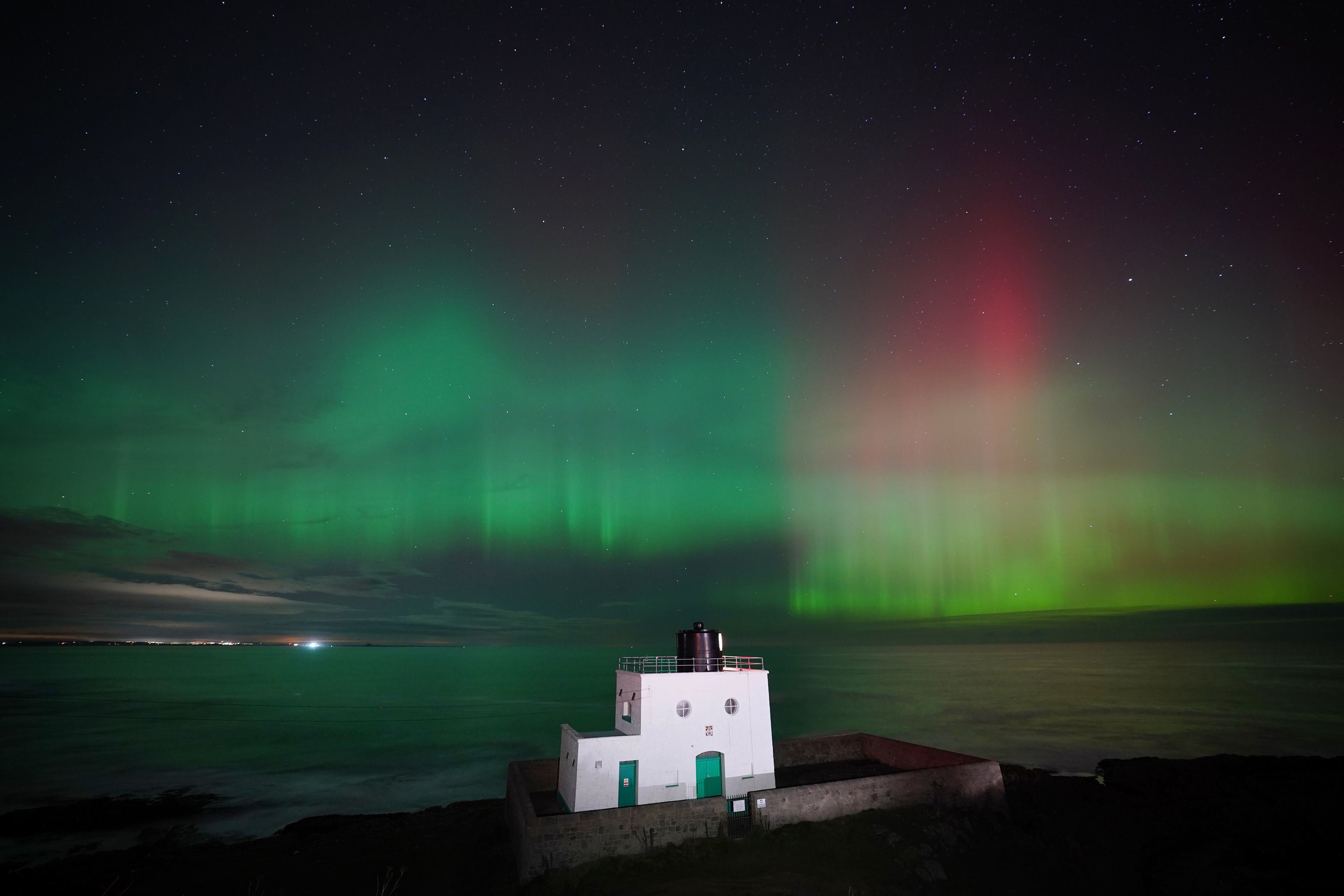 The aurora borealis, appeared over Bamburgh Lighthouse, in Northumberland, last month