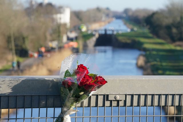 A bunch of red rose placed on the bridge across the Grand Canal in Tullamore, Co Offaly, where primary school teacher Ashling Murphy was found dead after going for a run (Niall Carson/PA)