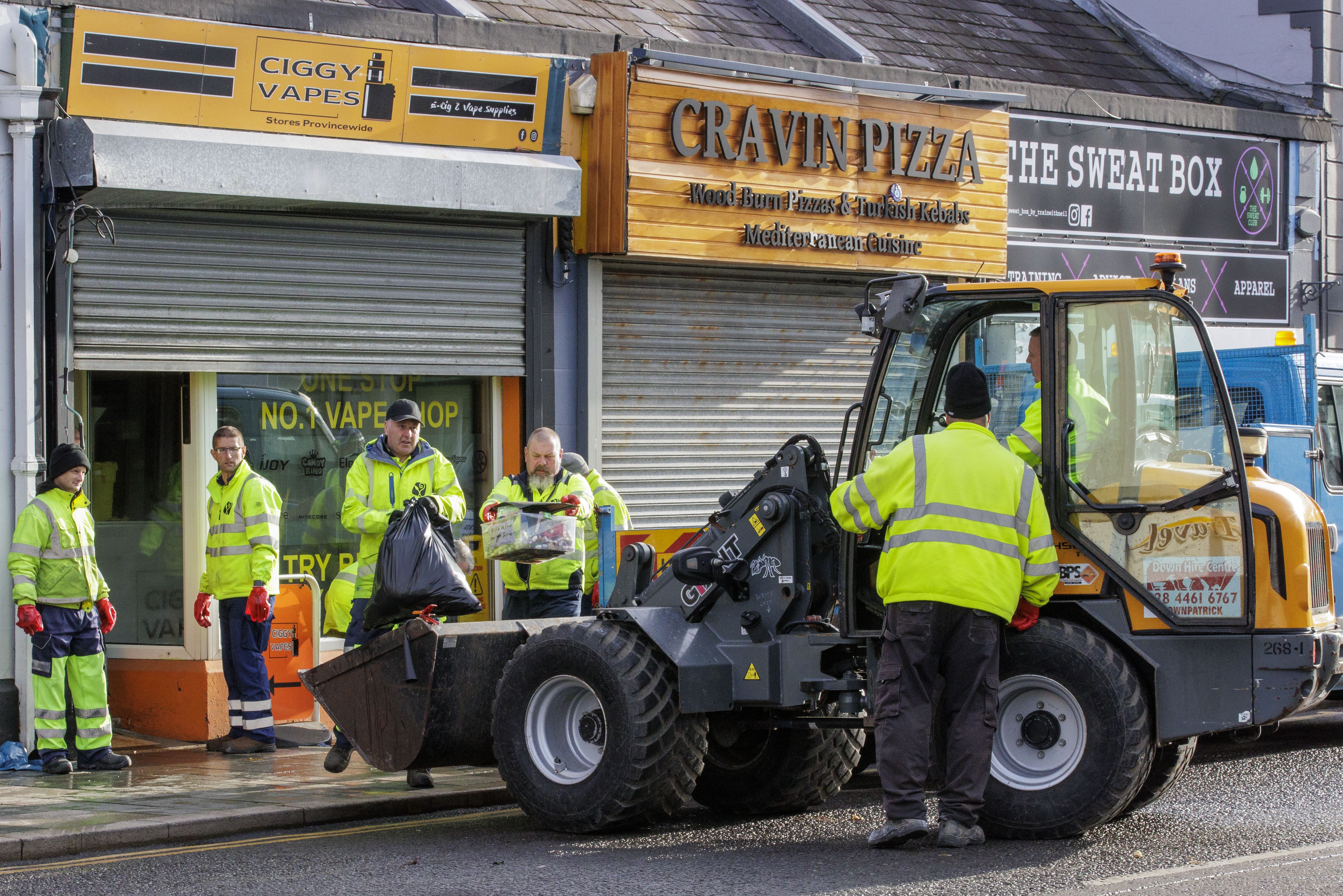 Council workers from Newry, Mourne and Down District Council help clean up flood-stricken Downpatrick, Co Down (Liam McBurney/PA)