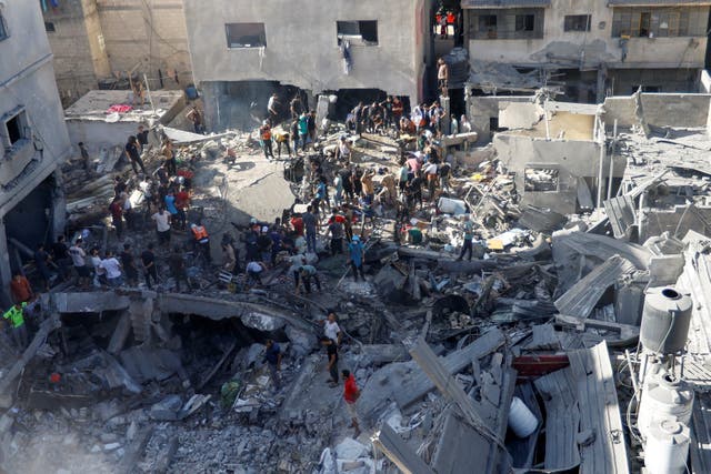 <p>Palestinians search for casualties at the site of an Israeli strike in Gaza</p>