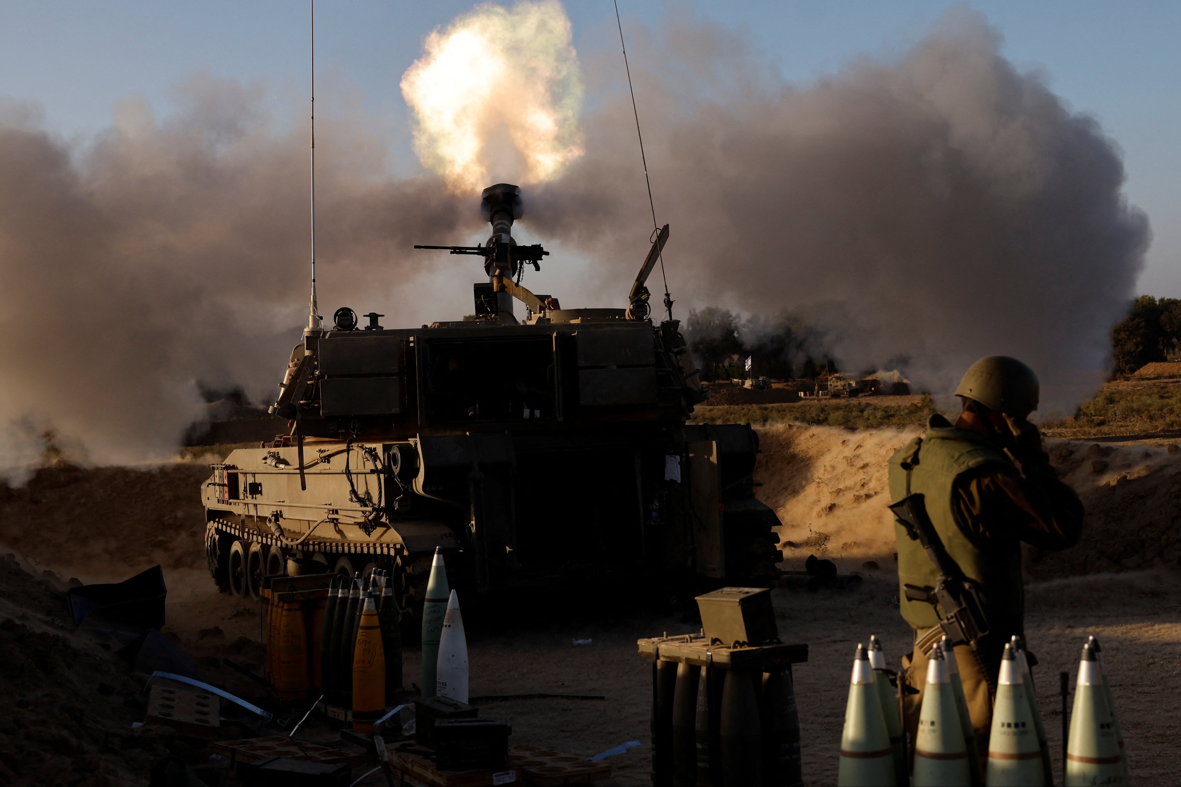 An Israeli artillery unit fires from an undisclosed location near the Gaza Strip