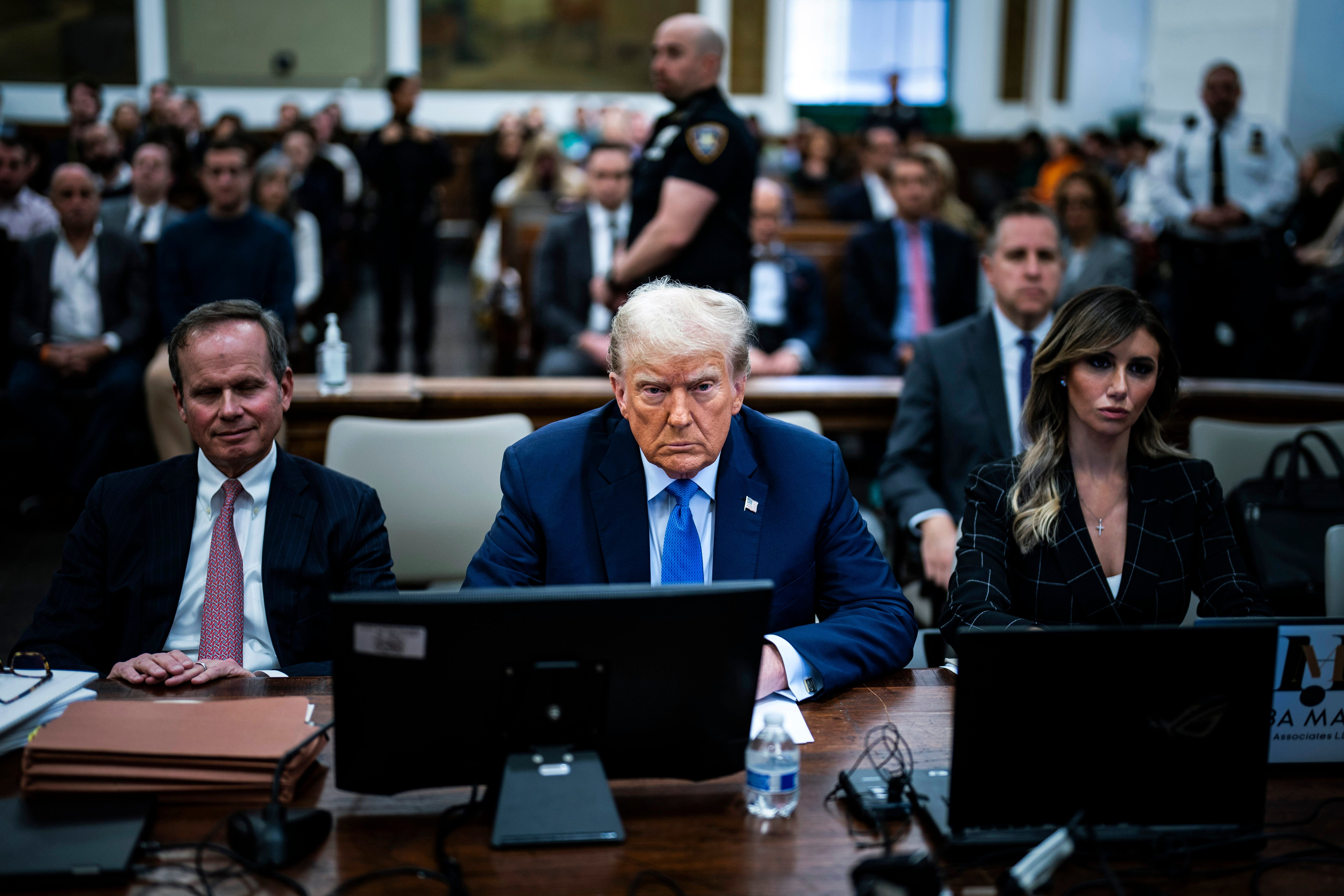 Donald Trump sits with his attorneys before his fraud trial testimony inside New York Supreme Court on 6 November