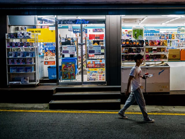 <p>A man walks past a convenience store along a street in Seoul. Representational</p>