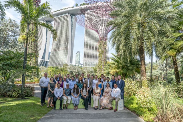 The Prince of Wales poses for a group shot with finalists at the base of the world famous ‘Supertrees’ in Gardens by the Bay, Singapore (Jordan Pettitt/PA)