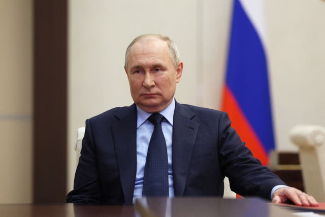 <p>Vladimir Putin attends a meeting officials at Novo-Ogaryovo state residence outside Moscow</p>