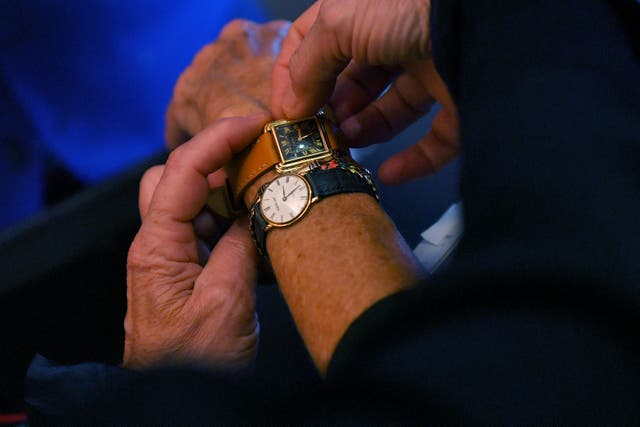 <p>A customer tries watches at a watchmaker shop on October 26, 2017 in Nantes, western France, two days before the end of Daylight Saving Time.</p>
