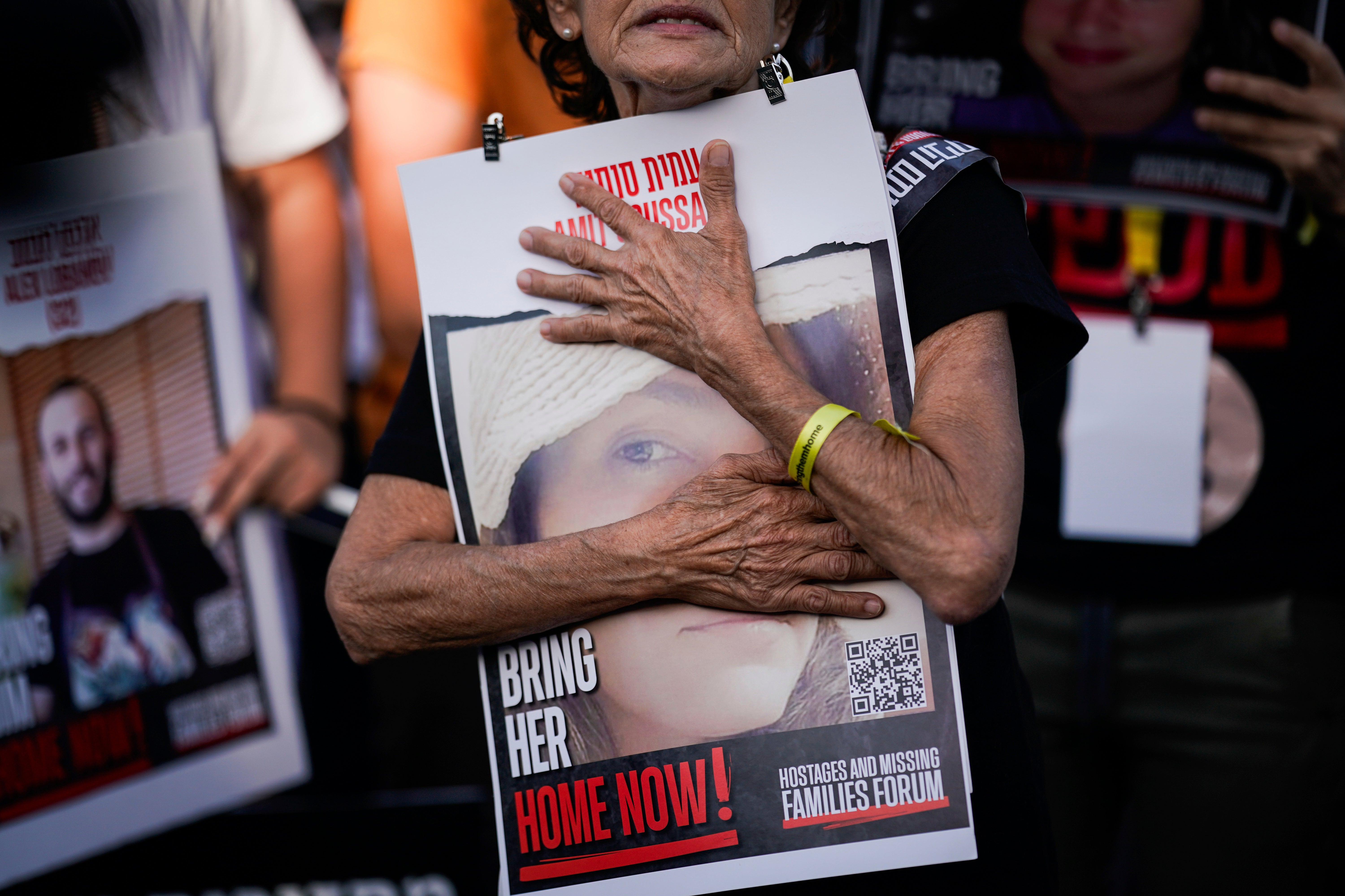 Relatives and friends of those kidnapped during the 7 October Hamas bloody cross-border attack in Israel, hold photos of their loved ones during a protest calling for their return