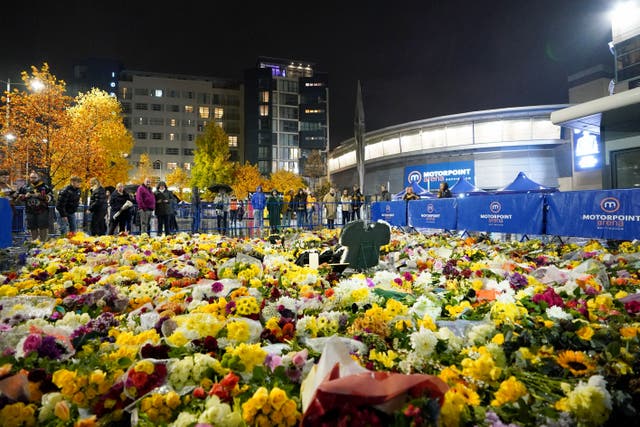 Fans look at floral tributes outside the Motorpoint Arena, Nottingham, ahead of a memorial for Nottingham Panthers’ ice hockey player Adam Johnson (Zac Goodwin/PA)
