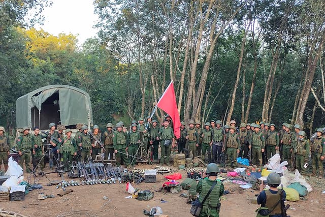 <p>Members of the Myanmar National Democratic Alliance Army pose for a photograph with the weapons allegedly seized from the Myanmar’s army outpost on a hill in Chinshwehaw town, Myanmar</p>