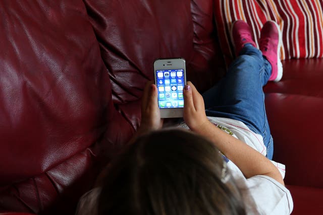 Generic stock photo of a child using an Apple iPhone smartphone (PA).