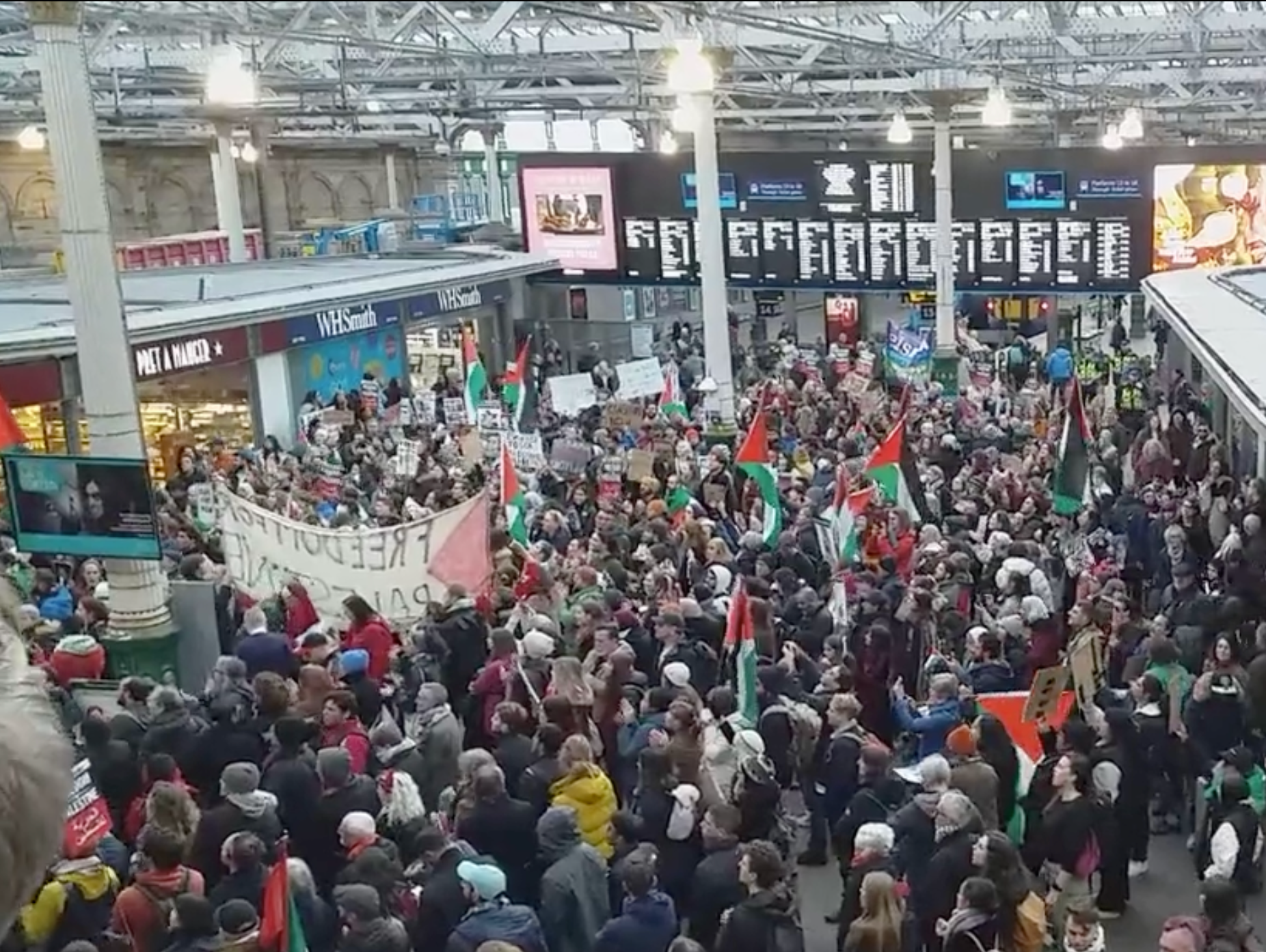 Protest at Edinburgh Waverley on Saturday - Mr Henderson can be seen stood behind a large banner.