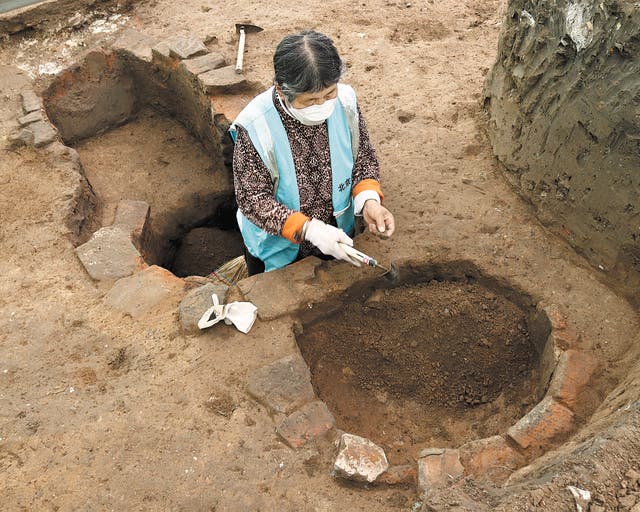 <p>A technician works on excavation at the Zhongdu site of the Jin Dynasty (1115-1234) in Beijing </p>