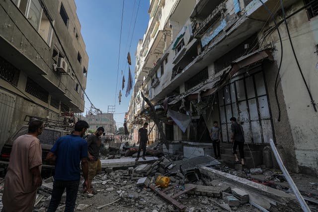 <p>Locals surveyed the destruction following Israeli air strikes in the Al Zaitun neighbourhood of Gaza City on Monday</p>