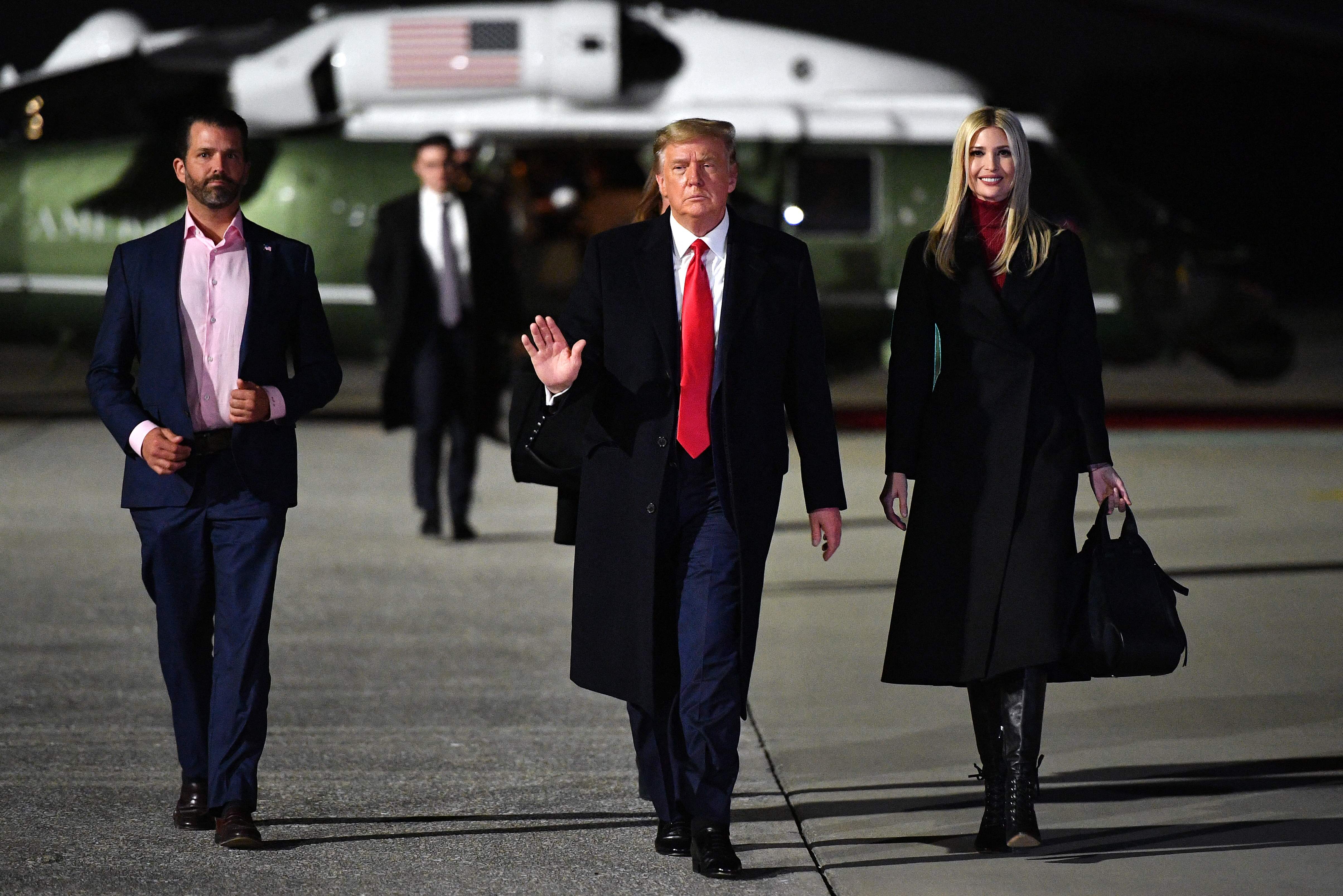 Ivanka Trump, right, boards Air Force One with her father Donald Trump and her older brother Donald Trump Jr, right, in January 2021