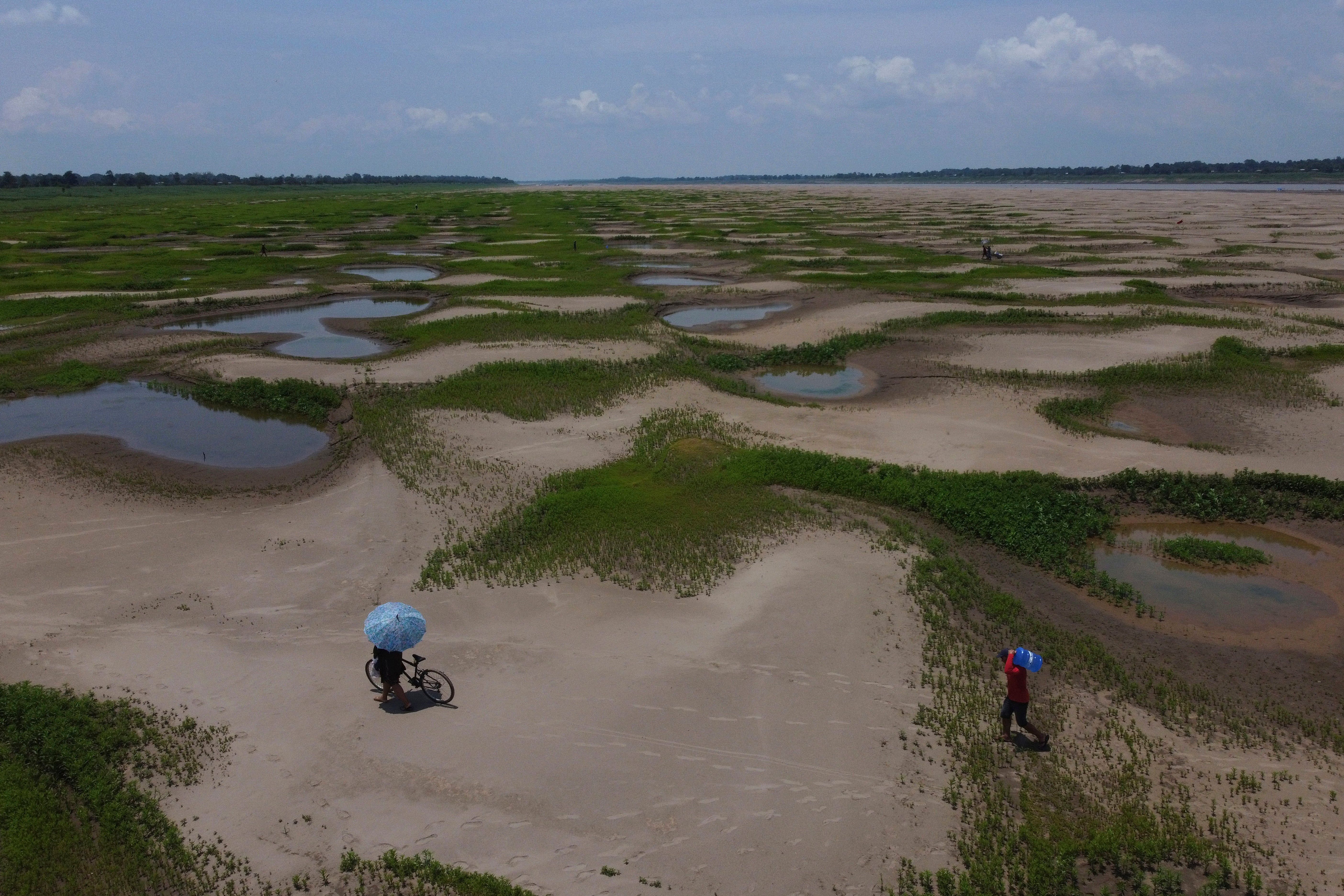 Residents of a riverside community carry food and containers of drinking water due to the ongoing drought and high temperatures that affect the region of the Solimoes River in Amazonas state, Brazil last month. The climate crisis is driving drought and water shortages around the world