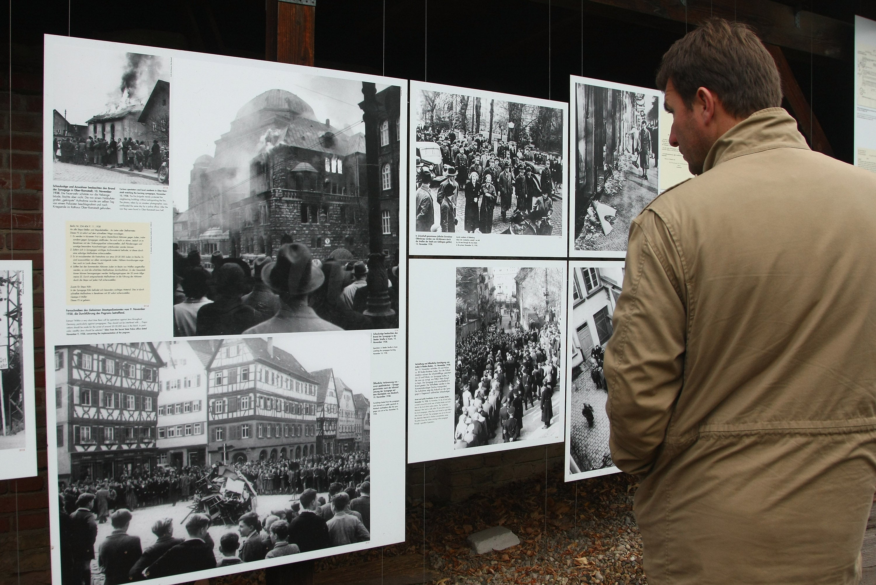 A visitor looks at a tableau documenting the Nazi Kristallnacht persecution of Jews in Germany at the Topography of Terror permanent exhibition in Berlin