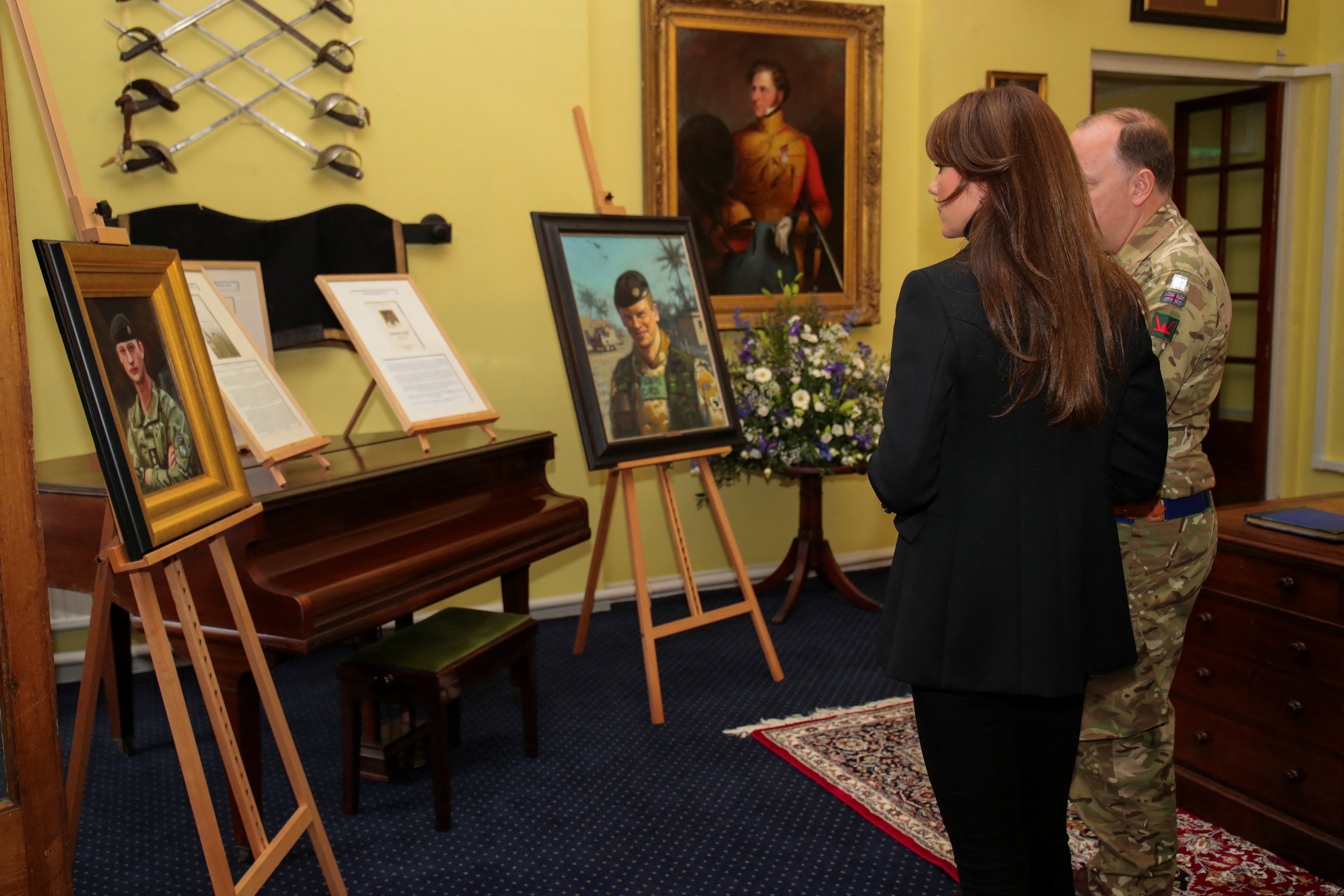 Princess of Wales looks at the pictures of the fallen soldiers of the Queen's Dragoon Guards Regiment