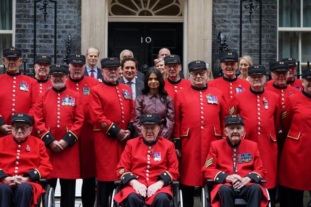 Akshata Murty with a group of Chelsea Pensioners in Downing Street (Lucy North/PA)