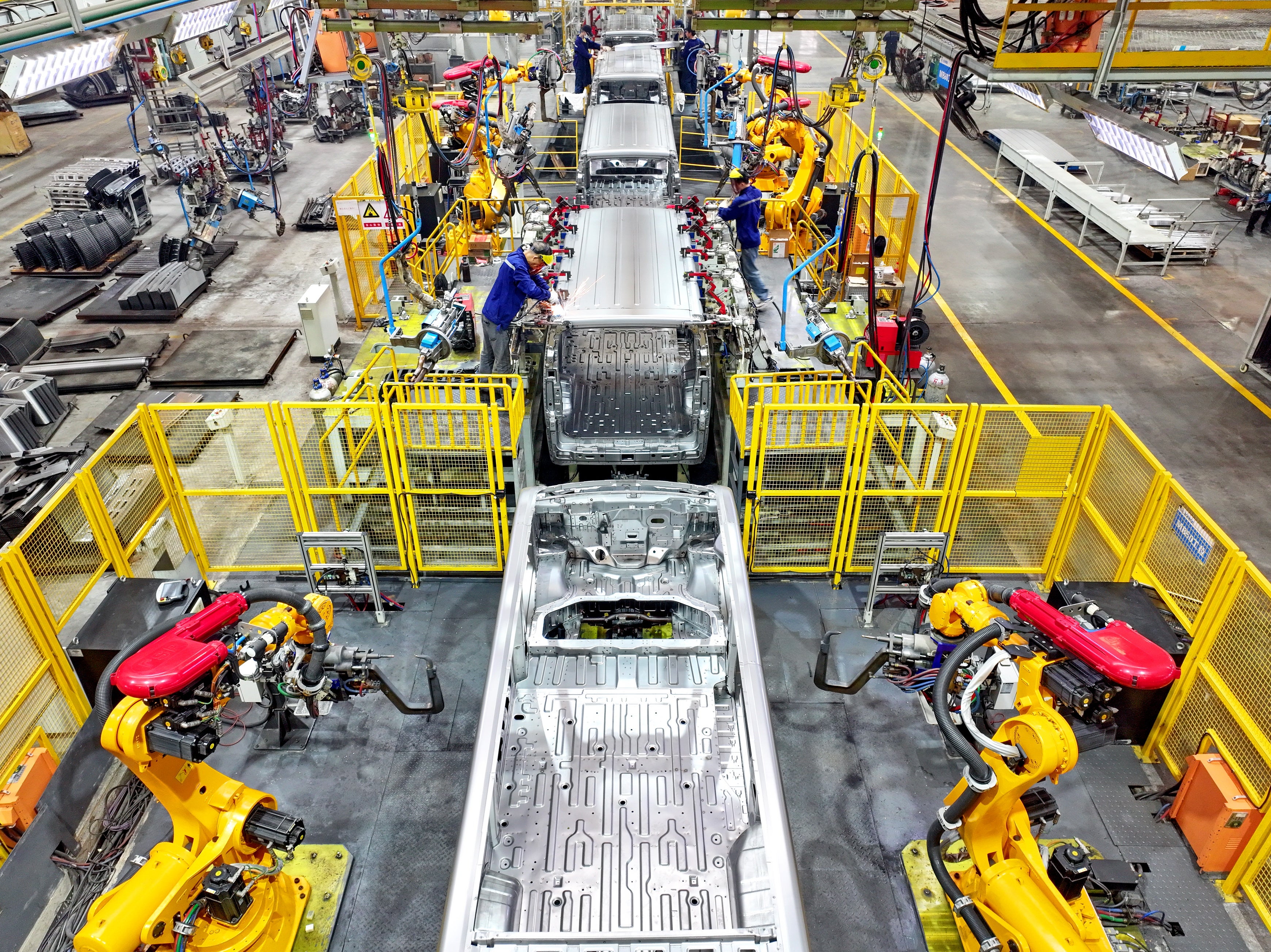 <p>Representational image: Robotic arms weld parts of electric express delivery vehicles on the assembly line at a factory</p>