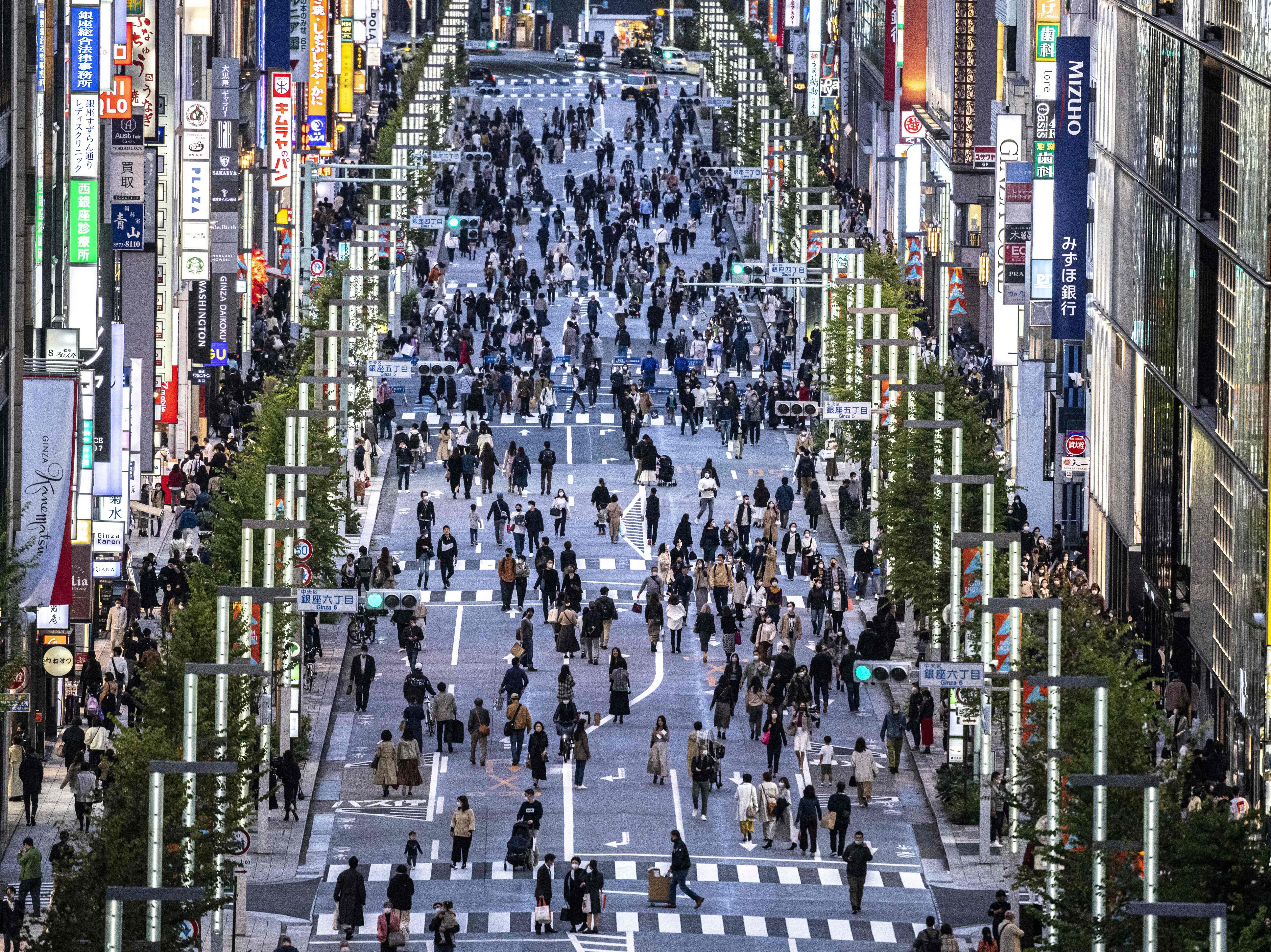 File. People walking on a street in Tokyo’s Ginza area at dusk