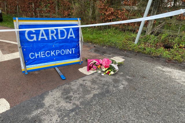 Flowers are left at a Garda checkpoint in Tullamore (Dominic McGrath/PA)