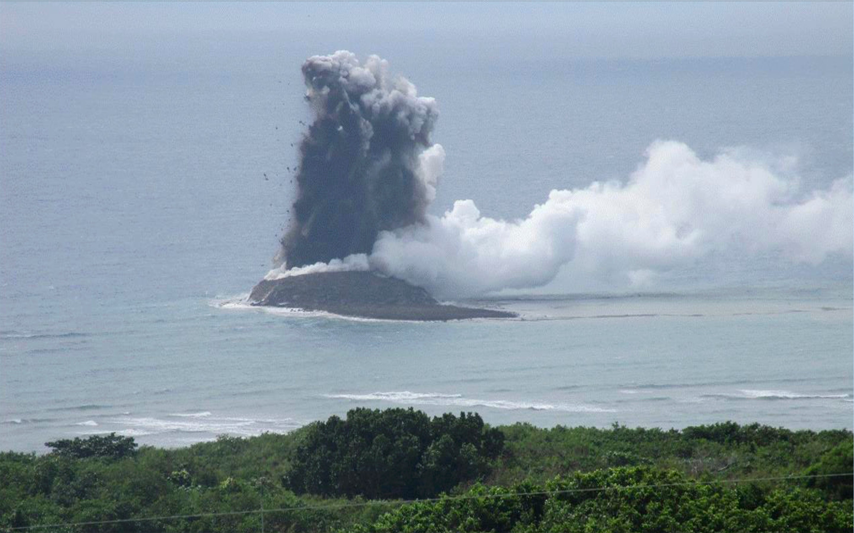 In this photo provided by the Japan Maritime Self-Defense Force, steam billows from the waters off Iwoto island, Ogasawara town in the Pacific Ocean